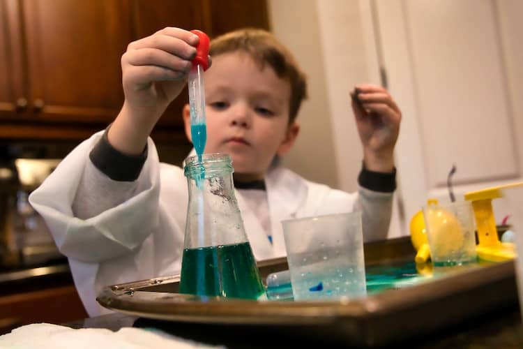 Boy in White Coat doing a science experiment