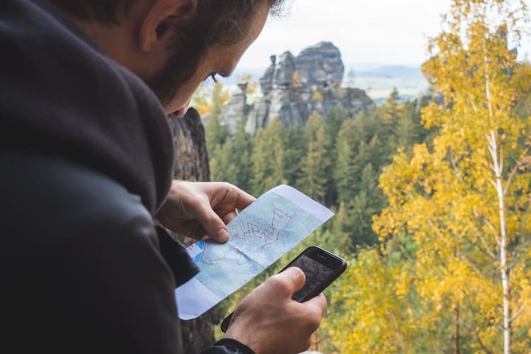 Using map and phone for day hiking essentials
