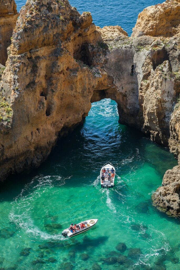 Boats and rock formations in ocean in Lagos