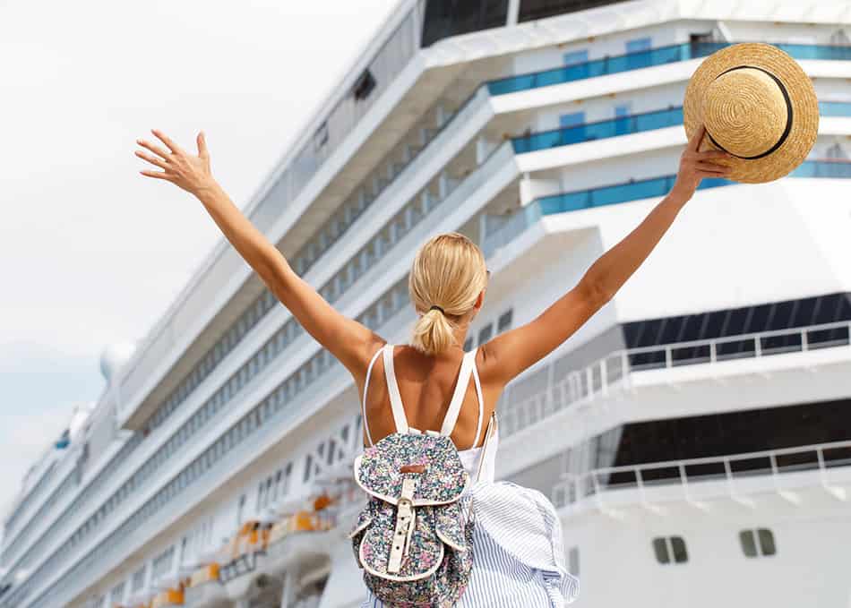 Woman tourist standing in front of big cruise liner, travel female