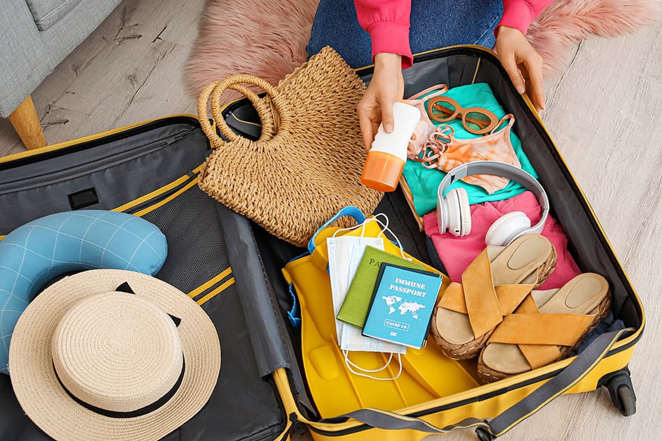 Summer Packing for Beach Sunscreen hat Passports Luggage