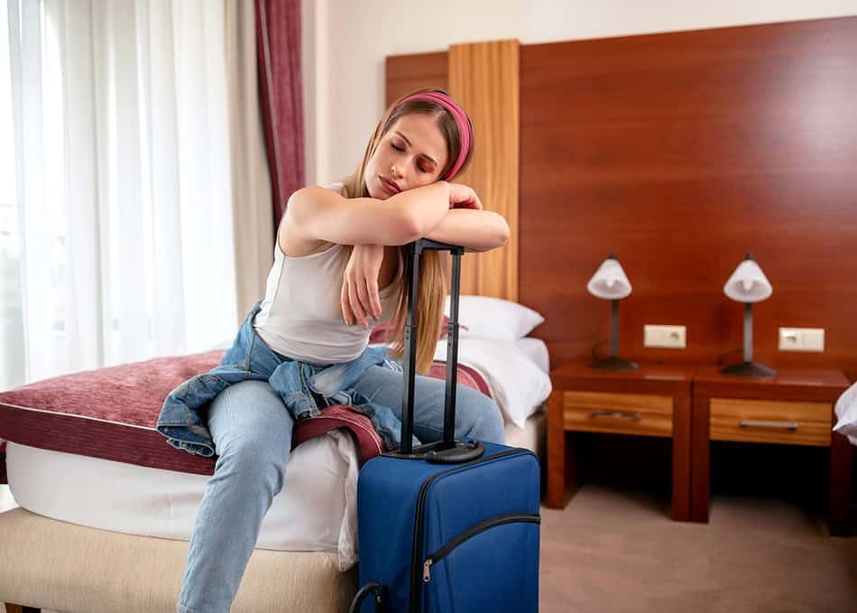 Tired in hotel room with luggage girl