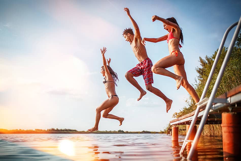 Jumping in lake summer friends